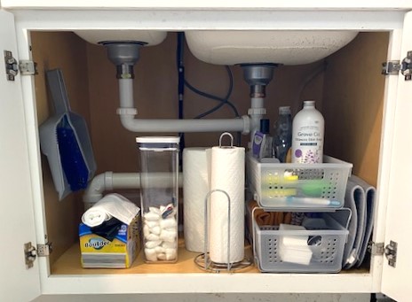 After decluttering, everything under the sink has a home. The 2-tier organizer helps to keep sponges and rags on the bottom tier while containing larger cleaning bottles in the top tier.