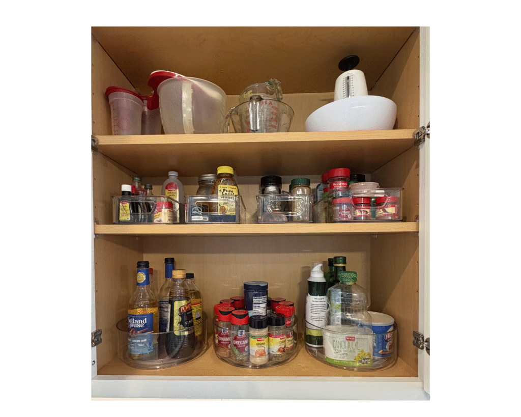 Kitchen organization inside a cabinet using clear turntables for spices, oils, and vinegars.