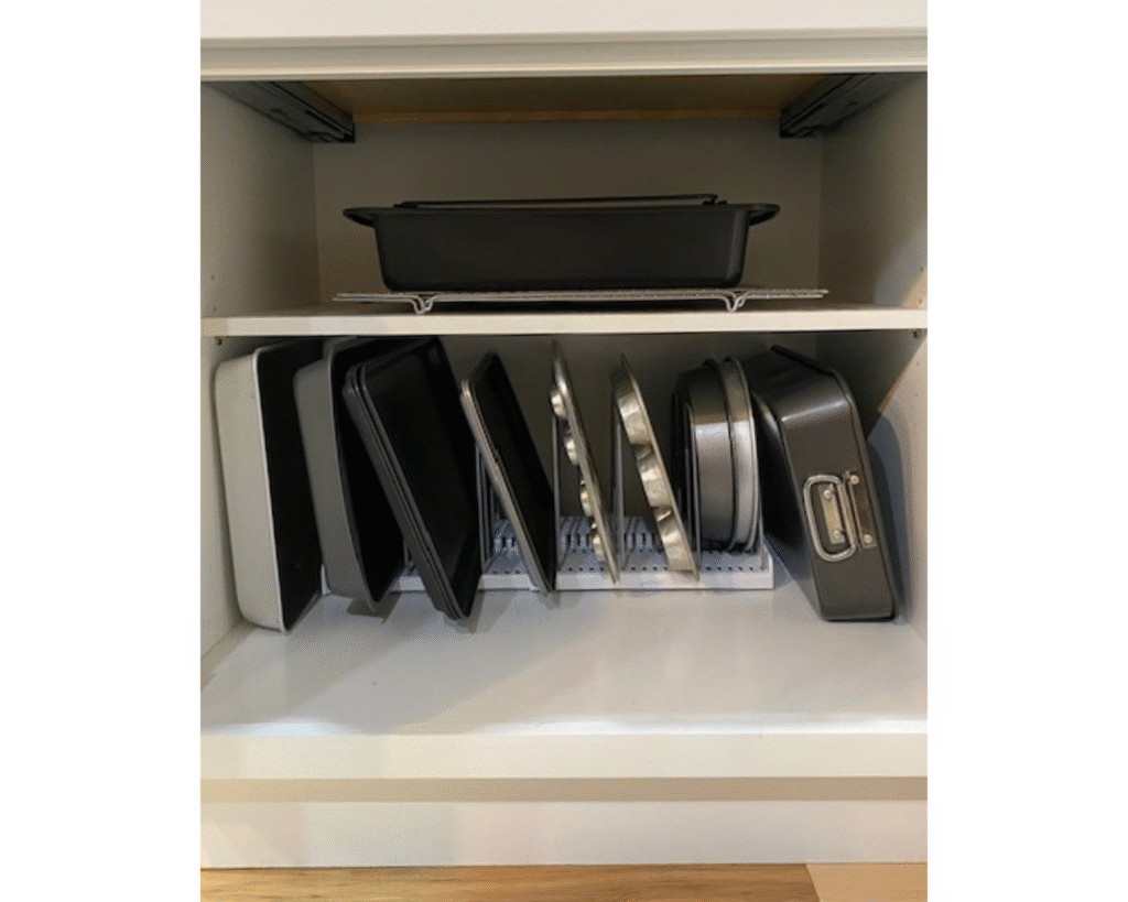 Kitchen organization for cabinets featuring the YouCopia expandable rack organizer holding baking sheets and pans vertically.